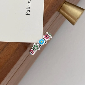 Macro view of colorful enamel flower patterns on a S925 silver open ring for women
