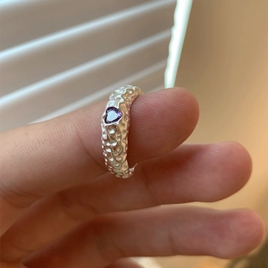 Macro shot of S925 silver ring with hammered texture and purple heart-shaped stone