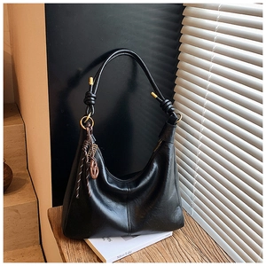 Detail of black Hobo shoulder bag with knotted strap and gold hardware accents