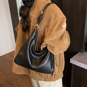 Classic black leather hobo shoulder bag with knotted strap and gold hardware accents