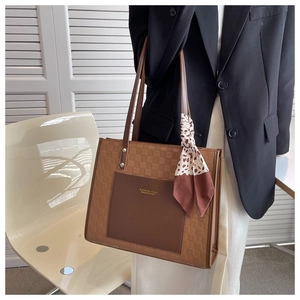 Brown leather tote bag with checkerboard pattern and leopard scarf detail