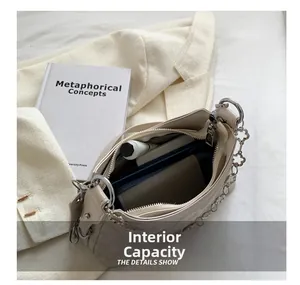 Interior view showing the large capacity of the quilted cream crossbody chain bag