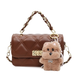 Quilted dark brown chain crossbody bag with golden hardware and plush dog charm