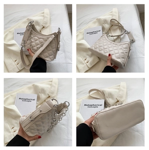 Detailed views of cream quilted shoulder bag with metal chain and Paris tag
