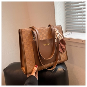 Close-up of retro brown checkered tote bag with leopard print scarf and shoulder strap