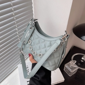 Quilted light blue crescent handbag with silver floral chain and leather shoulder strap