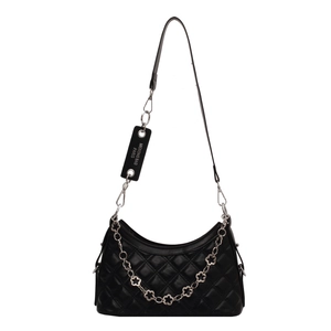 Quilted crossbody bag with flower-shaped silver chain and brand tag on white background