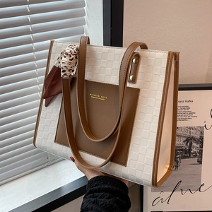 Minimalist beige checkered tote bag with brown leather accents and silk scarf decoration