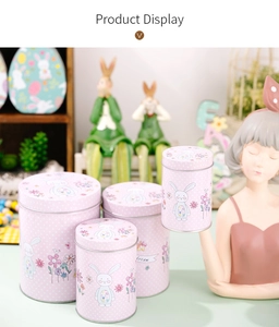 Detailed view of four pink polka dot Easter bunny tin storage boxes on a table