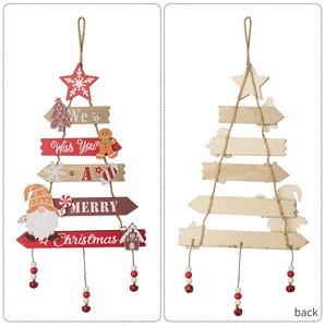 Close-up of wooden layered Christmas tree ornament with gingerbread man and bell