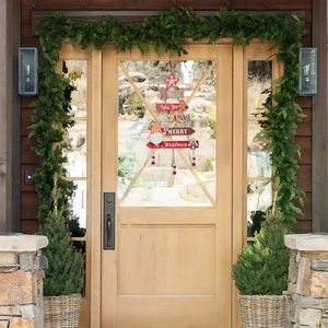 Detail of wooden Christmas tree door hanging with gingerbread man and gnome decor