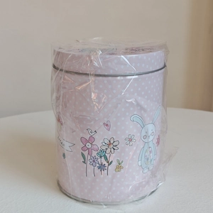 Close-up of pink Easter bunny tin can with white polka dots and cute floral pattern