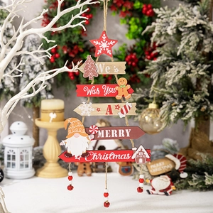 Hanging wooden Christmas tree sign with gingerbread man, gnomes, and festive bells