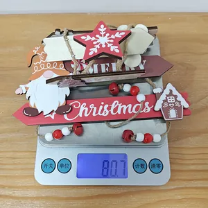Detail of Christmas wooden gingerbread man ornaments set on a scale weighing 80.7g