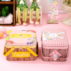 Tin Easter baskets with bunny and floral patterns and metal handles on pink background