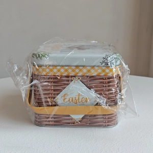Macro view of a brown woven-texture Easter tin basket with yellow handle and label
