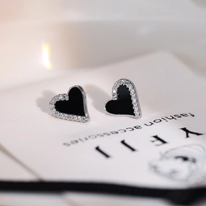 Asymmetric black heart-shaped stud earrings with rhinestone border and silver metal finish
