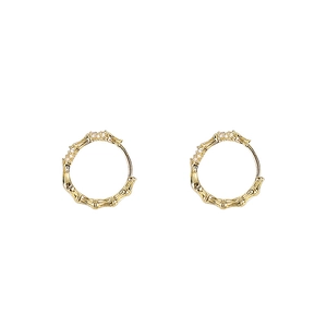 Elegant gold bamboo texture hoop earrings with sparkling micro diamonds on white background
