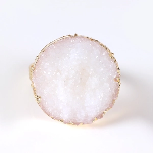 Macro detail of natural druzy quartz stone napkin ring with elegant gold electroplated edges