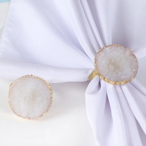 Detailed view of white crystal druzy napkin ring with elegant gold-rimmed circular stone