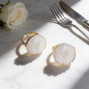 Luxurious white druzy natural stone napkin rings with golden rims for elegant dining decor