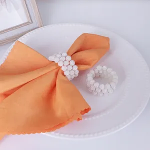 Elegant white beaded napkin rings with handmade pearl texture for wedding table decor