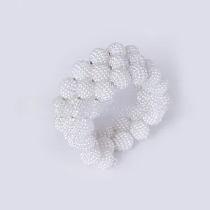 Detail of hand-woven pearl cluster napkin ring for elegant wedding table decor