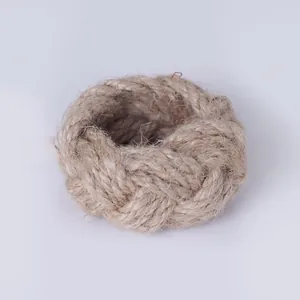 Close-up of a handmade braided jute rope napkin ring in a rustic farmhouse style