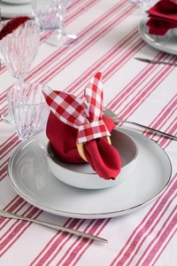 Close-up of red plaid bunny ear napkin rings on white ceramic bowl for Easter decor
