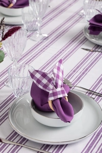 Detail of purple gingham bunny ear napkin ring on wooden loop for Easter table decor