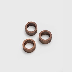 Set of 3 dark brown wooden napkin rings with natural grain for minimalist table decor