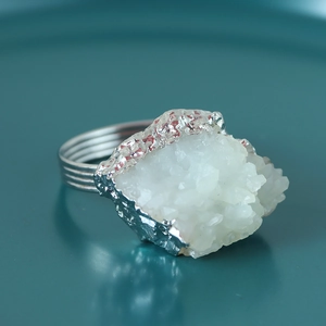 Macro detail of natural white crystal cluster ring with textured silver multi-layer band