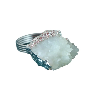 Silver napkin ring featuring a large raw white druzy quartz crystal for table decor