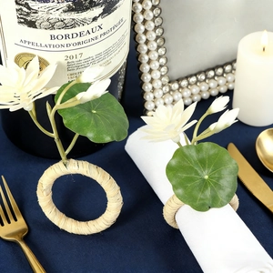 European style lotus napkin rings with white flowers and green leaves on woven raffia bands