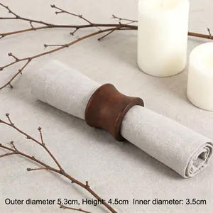 Modern dark wood hourglass napkin ring with natural grain shown with dimension specs