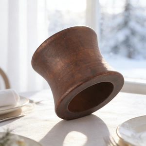 Vintage hourglass wooden napkin ring with natural grain on a white tablecloth