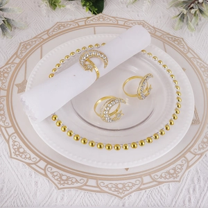 Elegant gold crescent moon and star napkin rings with sparkling rhinestones for dinner decor