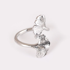Silver ginkgo leaf napkin ring with polished metal texture on a clean white background