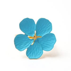 Detailed view of light blue plum blossom napkin ring with textured petals and golden core