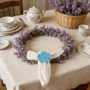 Light blue flower napkin ring on a white napkin inside a lavender wreath decoration