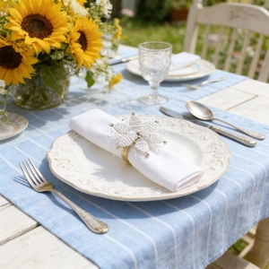 Handmade white beaded flower napkin ring with gold band on a patio dining table
