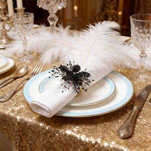Handmade black beaded flower napkin ring with crystals on blue and white plate
