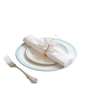 Handmade beaded snowflake napkin ring with white pearls on a gold band for elegant dining
