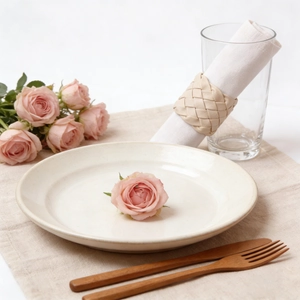 Elegant handwoven cream leather napkin ring set on a modern minimalist dining table