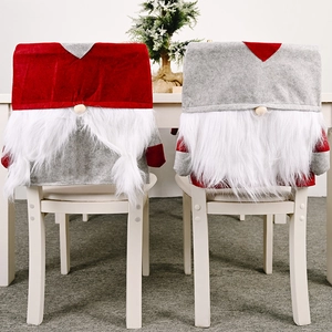 Close-up of gray and red felt Christmas gnome chair covers with white faux fur beard
