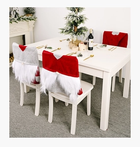 Festive Christmas chair covers with gnome design and white beard on white wooden chairs