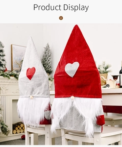 Cozy Christmas gnome chair covers on white dining chairs in festive home interior scene