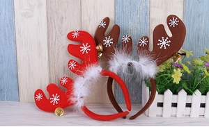 Detail of Christmas reindeer antler headbands with white snowflakes, bells and plush trim