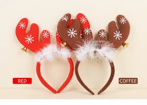 Detail of Christmas reindeer antlers headband with white feathers and golden bells