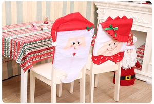 Detailed view of red Christmas chair covers with Santa and Mrs. Claus embroidery